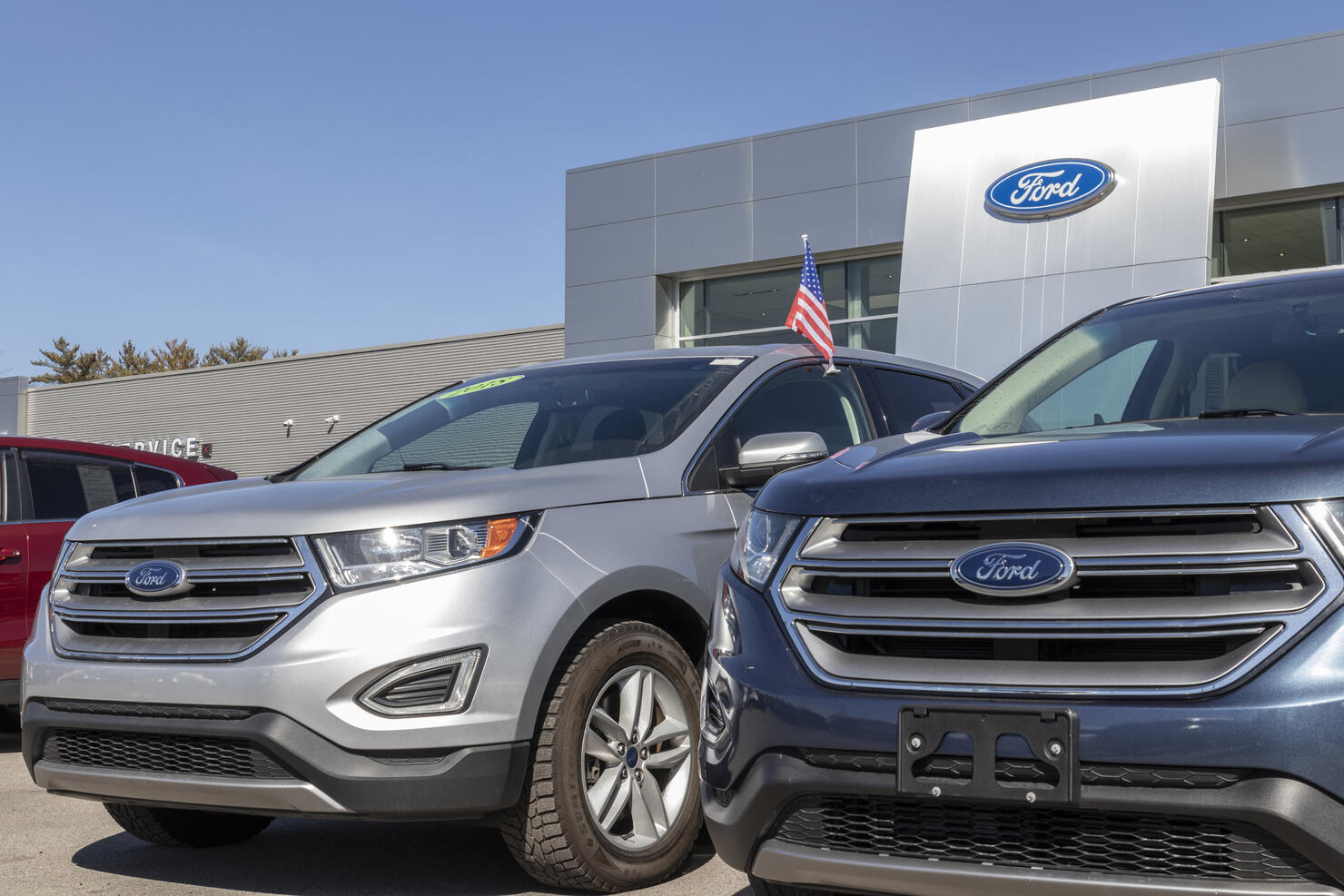 Ford SUV display at a dealership. Ford sells traditional gasoline, electric and hybrid SUV models.