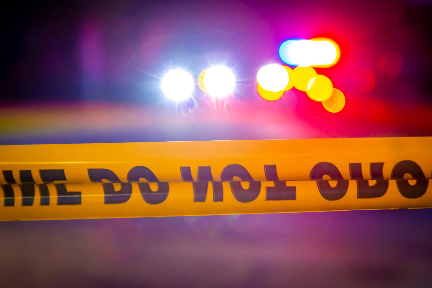 Generic police lights and yellow police tape at crime scene