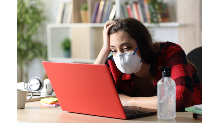 Bored student looking laptop in coronavirus confinement