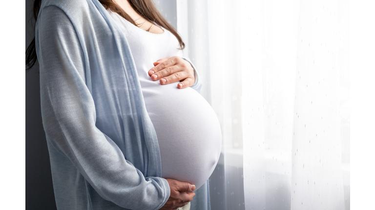 healthy pregnancy. Side view pregnant woman with big belly advanced pregnancy in hands. Banner copyspace for text. Elegant mother waiting baby