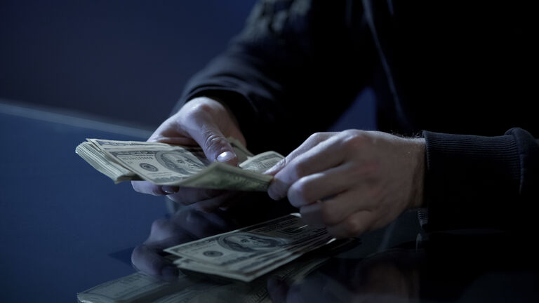 Male hands counting dollars, black salary, money laundering, illegal business