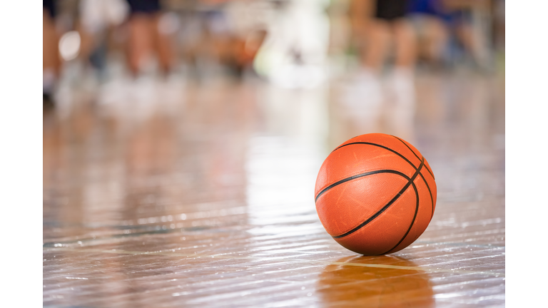 Bright gymnasium and basketball on the floor