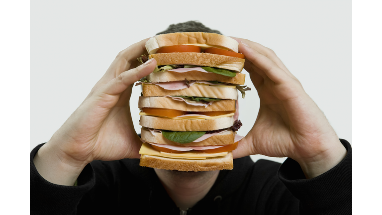 A man holding a large sandwich