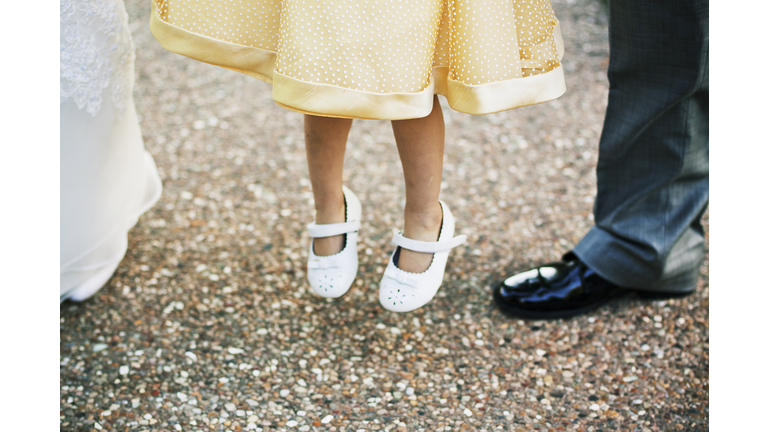 Close up of flower girl jumping for joy