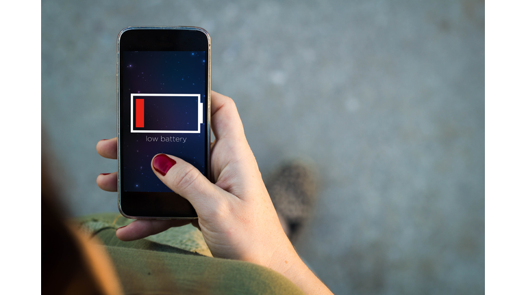 Woman walking smartphone low battery