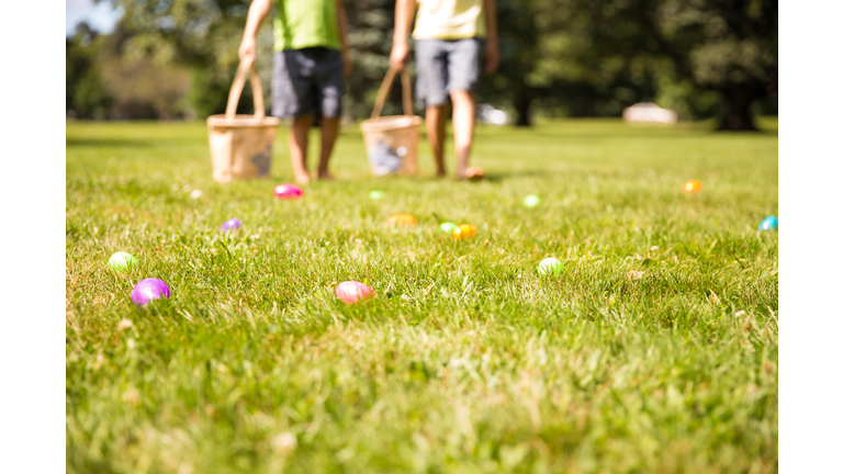 easter eggs hunt. Blurred silhouettes of children with baskets in hands.