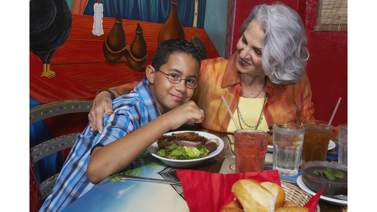 Close-up of a boy with his grandmother in a restaurant