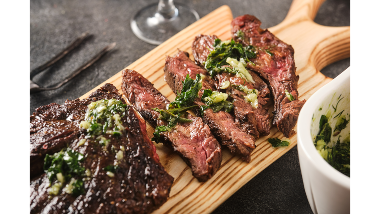 Hanger steak bbq with souce chimichurri, close up