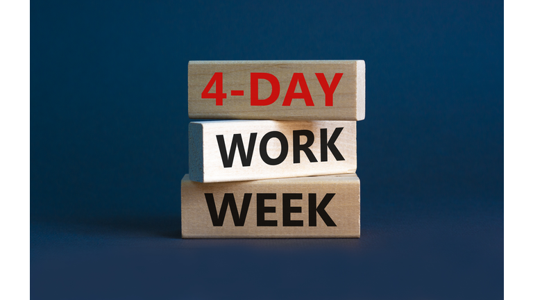 4-day work week symbol. Concept words '4-day work week' on wooden blocks. Beautiful grey background. Copy space. Business and 4-day work week concept.