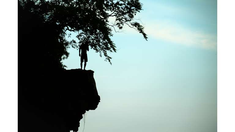 The man thinking something before cliff jump