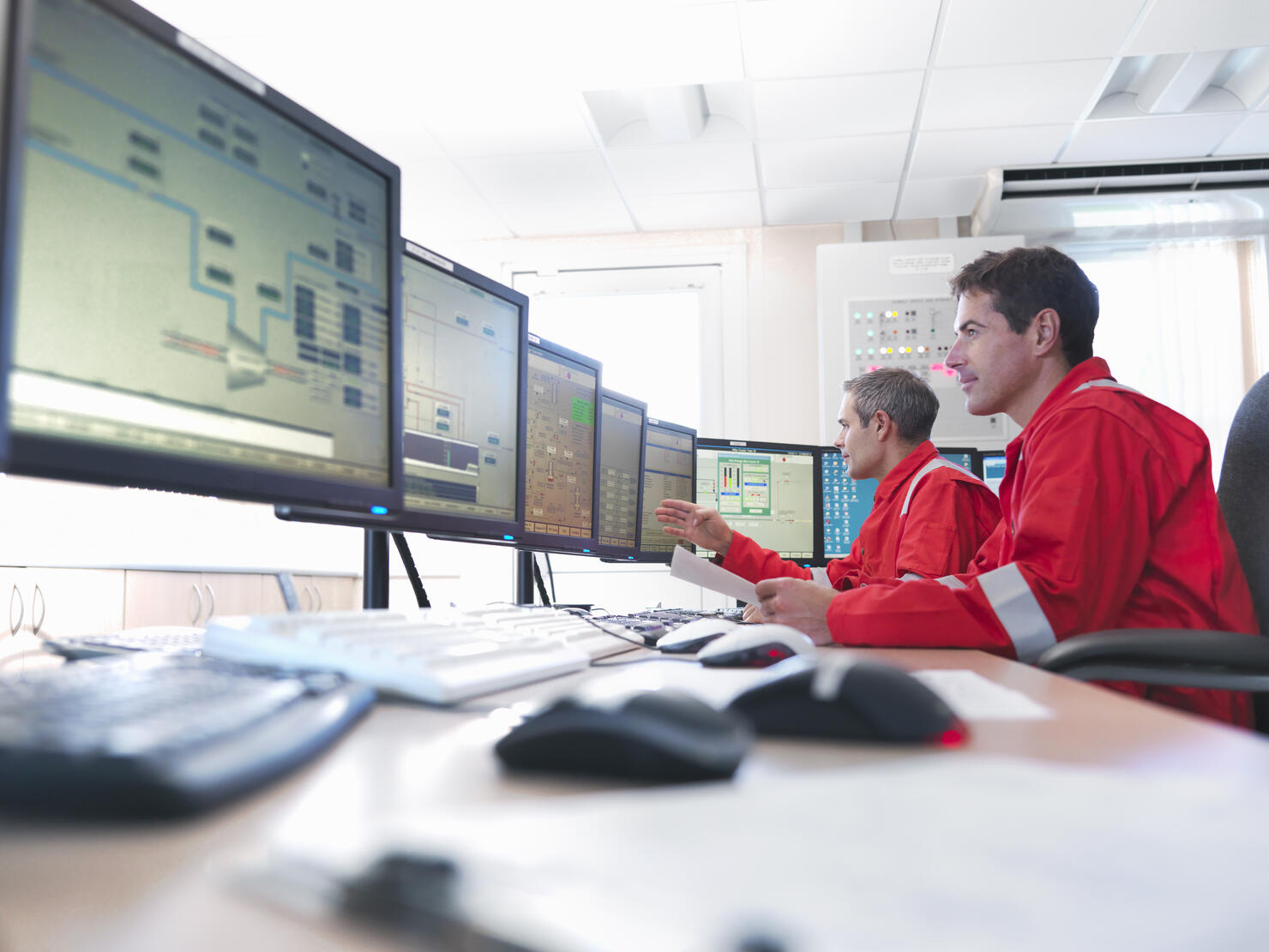 Workers in control room of gas plant