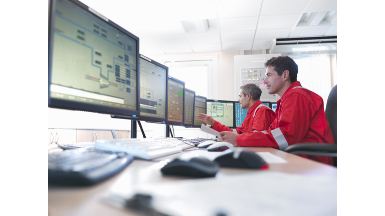 Workers in control room of gas plant