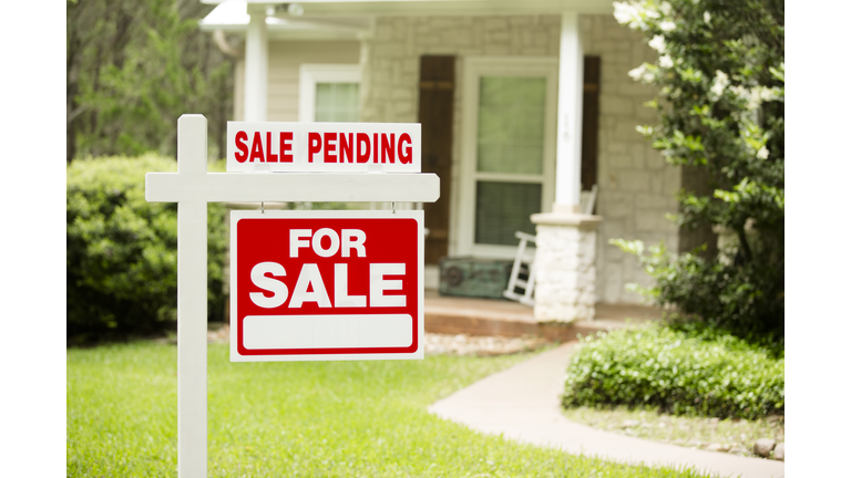 House for sale, pending sign in front yard. No people.