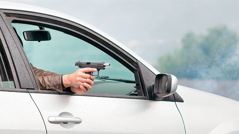The car is explosive in front and is shooting a pistol.
