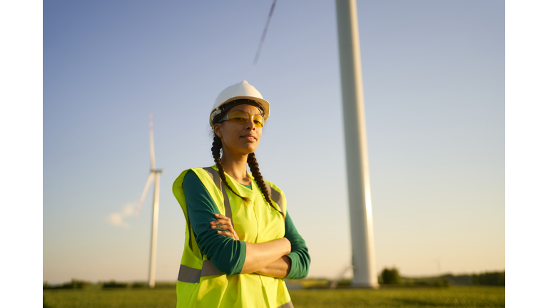 Female engineer setting up wind turbine.