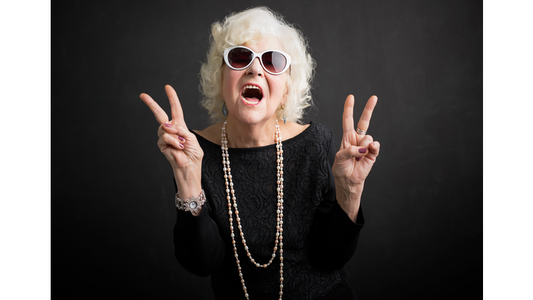 Cool grandmother showing peace sign