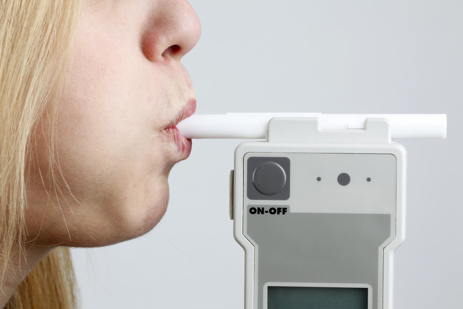 Woman Blowing in Breathalyzer