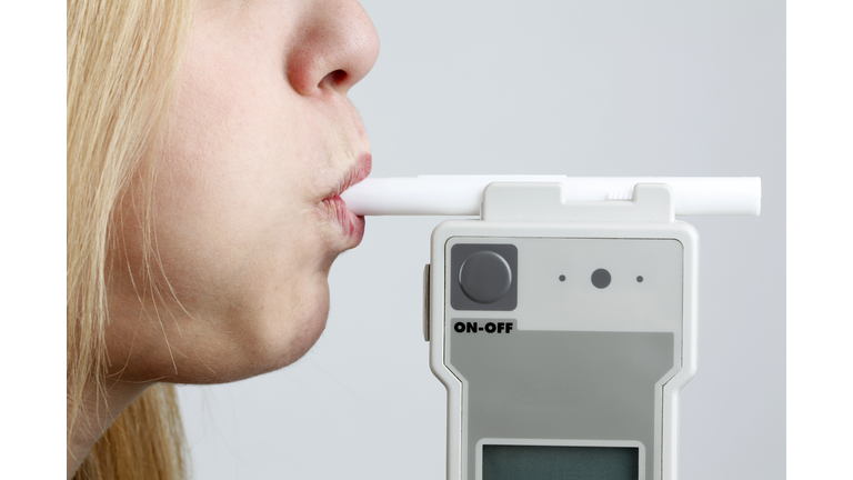 Woman Blowing in Breathalyzer