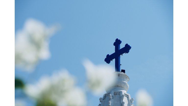 Holy cross in church top. Christian cross symbol. Easter. Crucifix. Holy cross symbol in natural scenic frame.