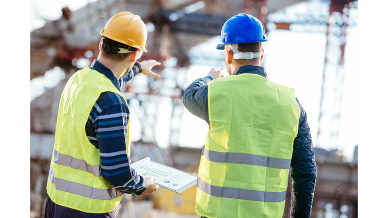 Engineer and contractor having brief meeting on construction site