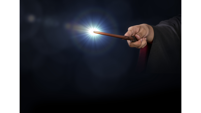 Magic wand with sparkle on blue background, Miracle magical stick Wizard tool on hot blue.