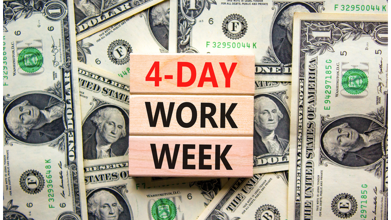 4-day work week symbol. Concept words 4-day work week on wooden blocks on beautiful background from dollar bills. Copy space. Business and 4-day work week and short workweek concept.