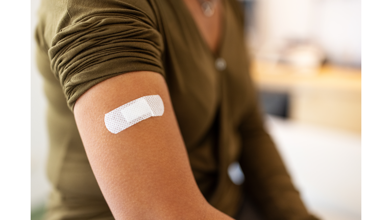 Bandage on arm of a female after taking vaccine