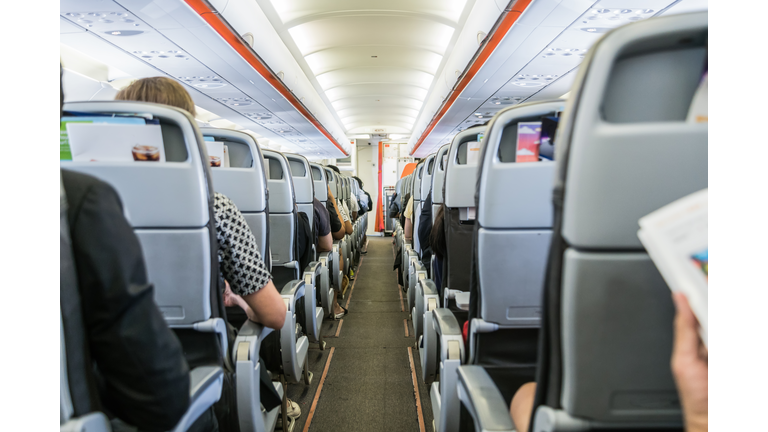 airplane with passengers on seats waiting to take off