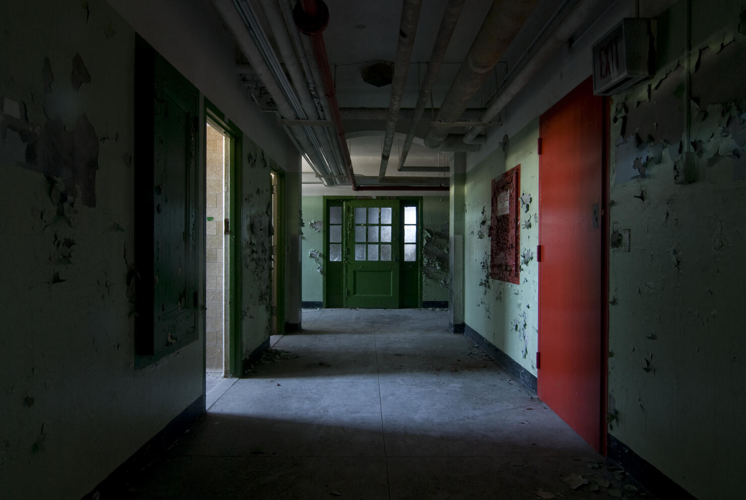 Interior basement hallway inside abandoned mental asylum