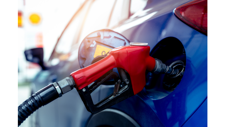 Car fueling at gas station. Refuel fill up with petrol gasoline. Petrol pump filling fuel nozzle in fuel tank of car at gas station. Petrol industry and service. Petrol price and oil crisis concept.