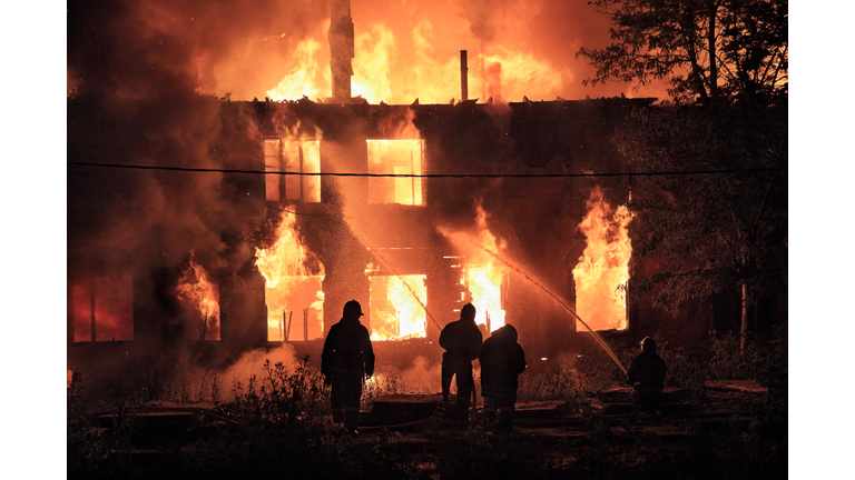 firefighters silhouettes on fire background