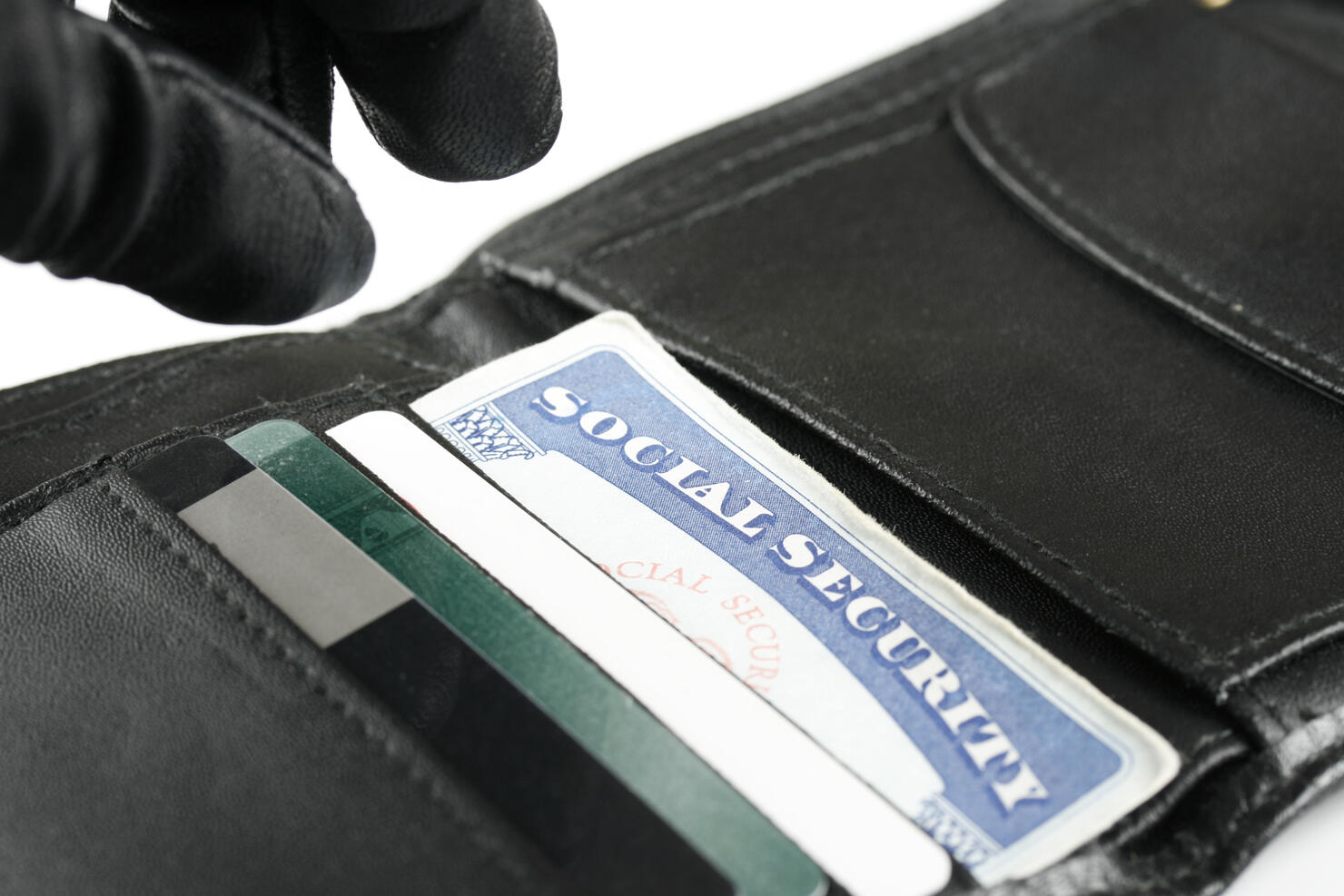 Identity Thief's Hand Reaching for Social Security Card in Wallet