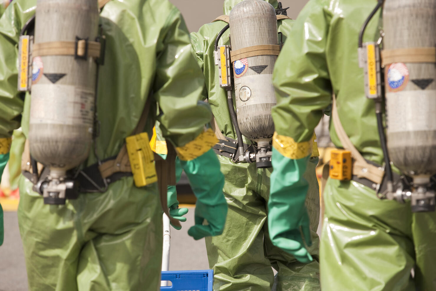 Rear view of HazMat firefighters with air tanks