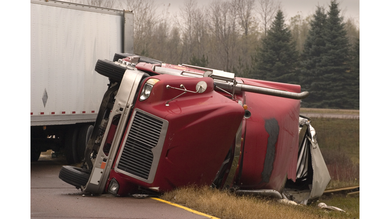 Truck crash with turned over semi