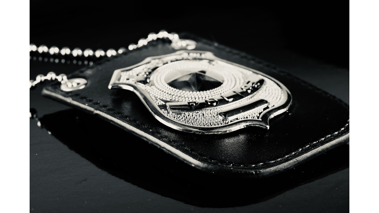 police detective badge against a black background