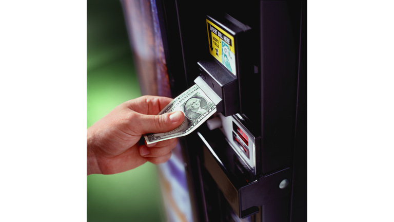 Placing Dollar in Vending Machine