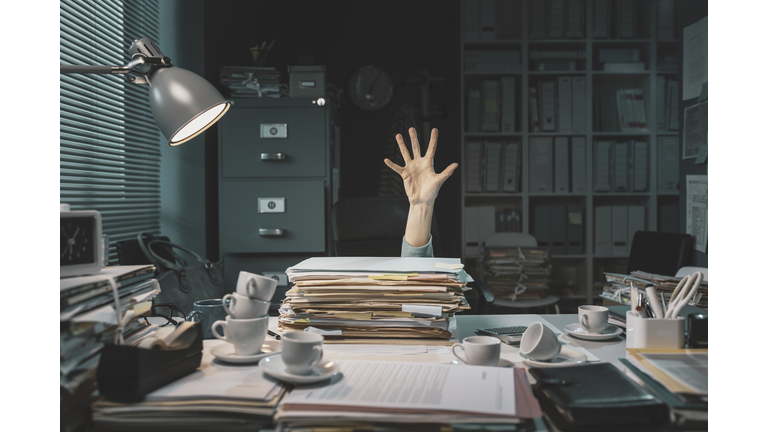 Office worker overwhelmed with paperwork