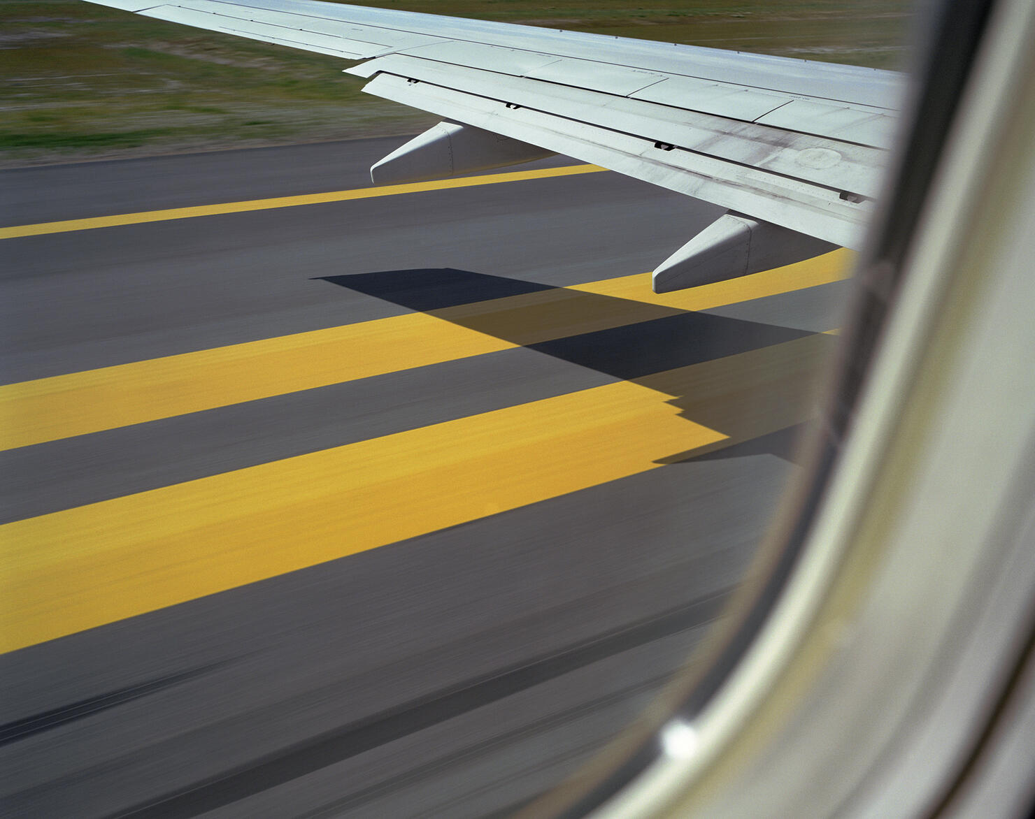 Aeroplane about to take off, shadow of wing on runway