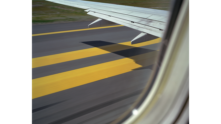 Aeroplane about to take off, shadow of wing on runway