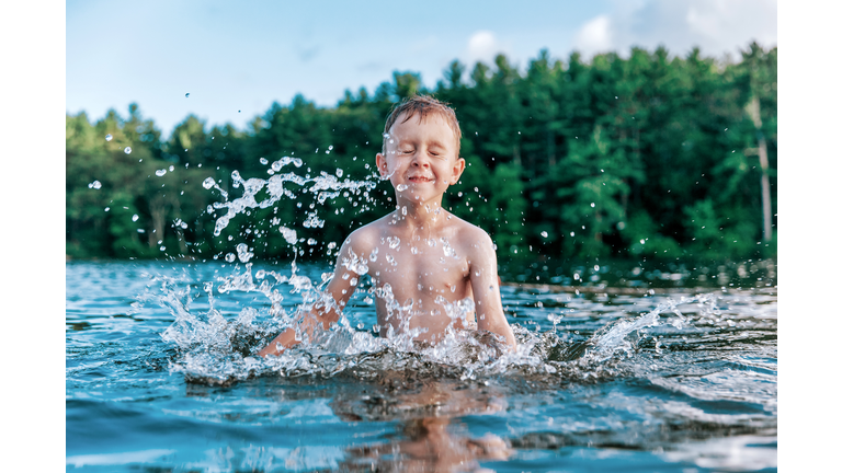 boy splashes in the lake