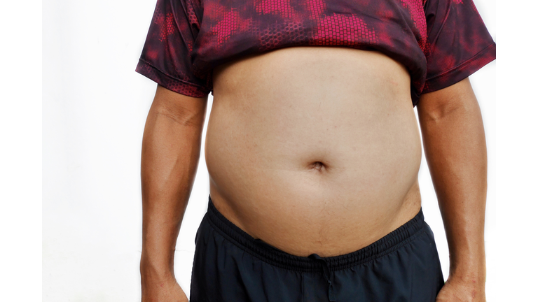 Midsection Of Fat Man Against White Background