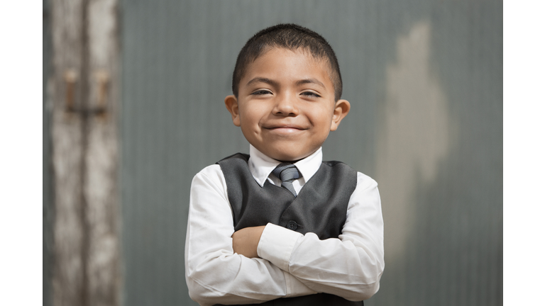 Hispanic boy wearing formal suit