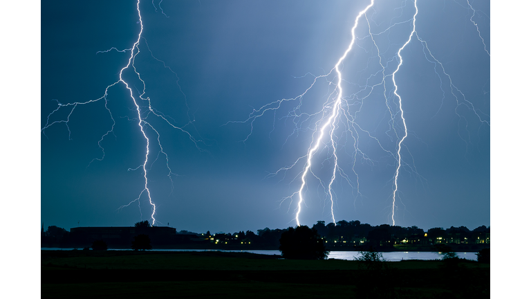 Branched lightning strikes close to a river