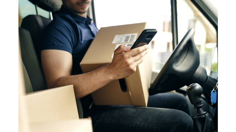 Close up of checking a package using portable information device