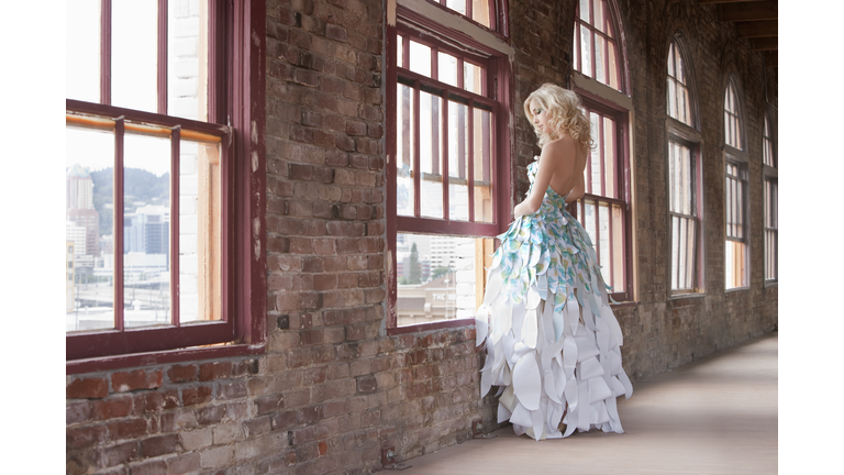 Beautiful Young Woman Fashion Model, Paper Gown, Standing at Windo