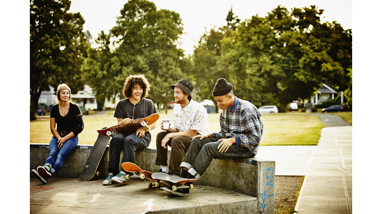 Skateboarders hanging out in skate park