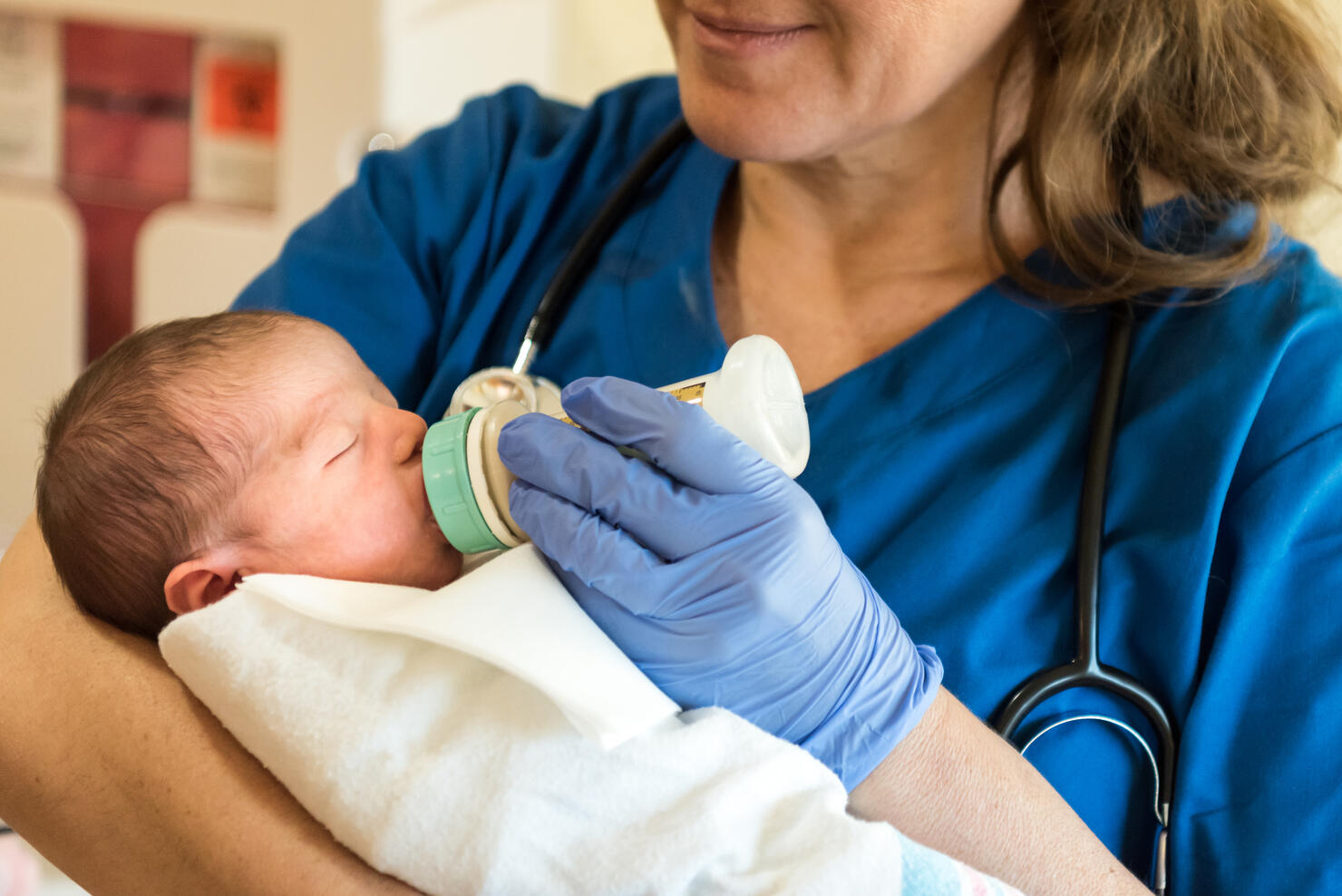 Female Nurse feeding a newborn