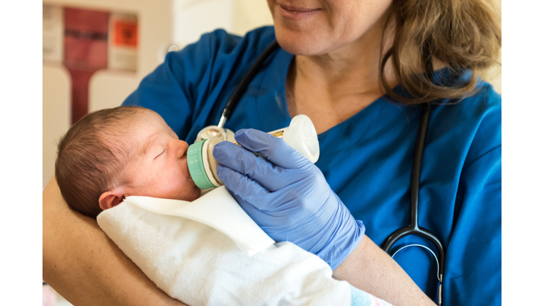 Female Nurse feeding a newborn