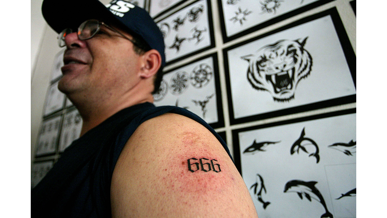 A man shows a tattoo with the number 666...