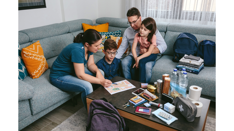 Mother explaining to her family the emergency assembly point
